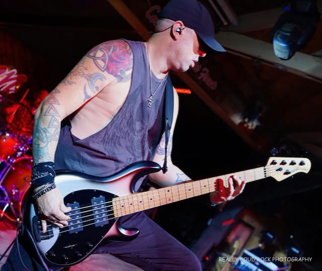 Human-Clay-Bass-Player-On-Stage-Performing